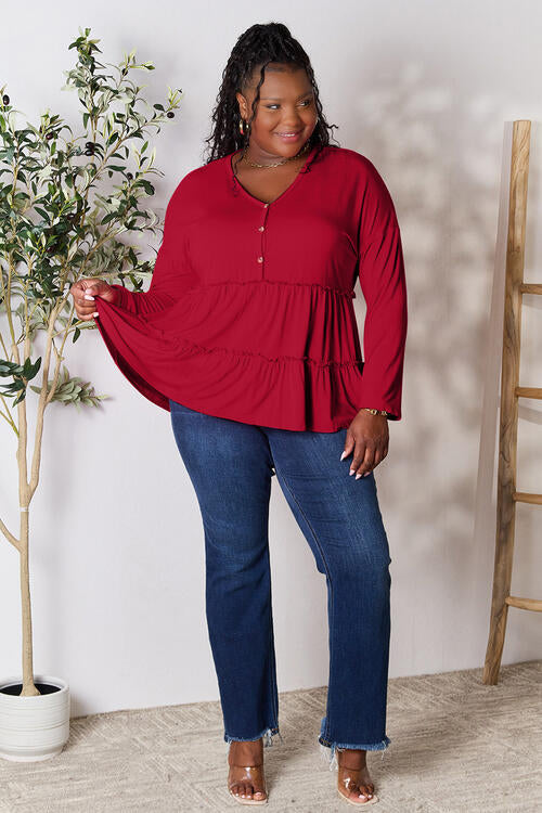 Double Take Half Button Long Sleeve Ruffle Hem Blouse in a stylish design with ruffle hem and half-button closure.