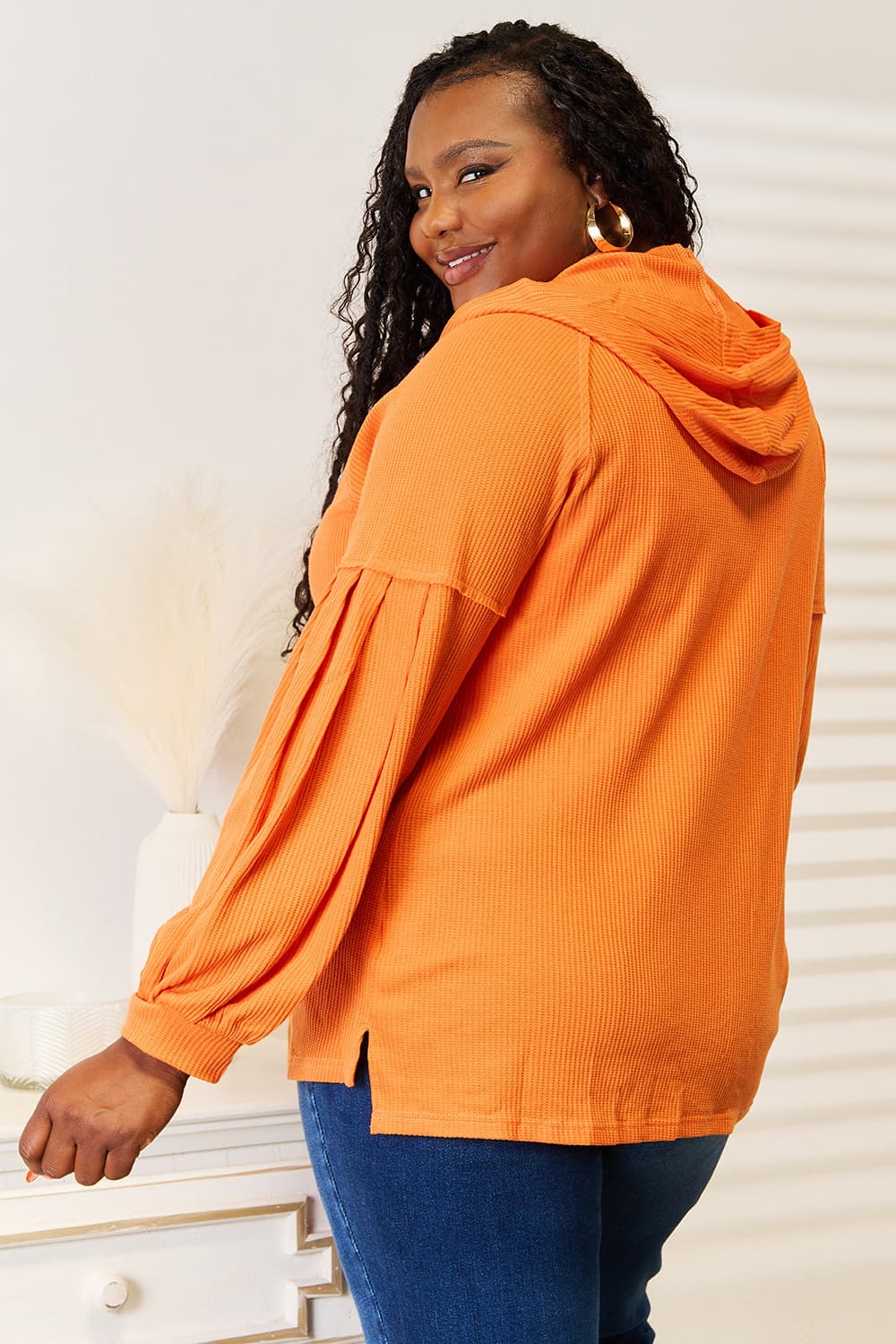 Double Take Side Slit Buttoned Waffle Knit Hoodie in a cozy waffle knit fabric with stylish side slits and button details.