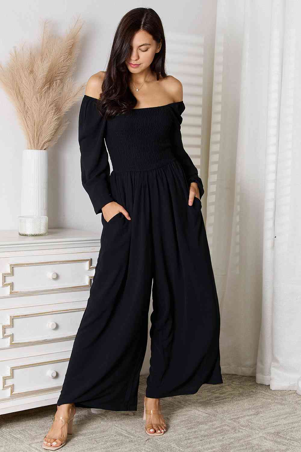 A stylish Double Take Square Neck Jumpsuit featuring pockets, showcasing its elegant design and smocked details.