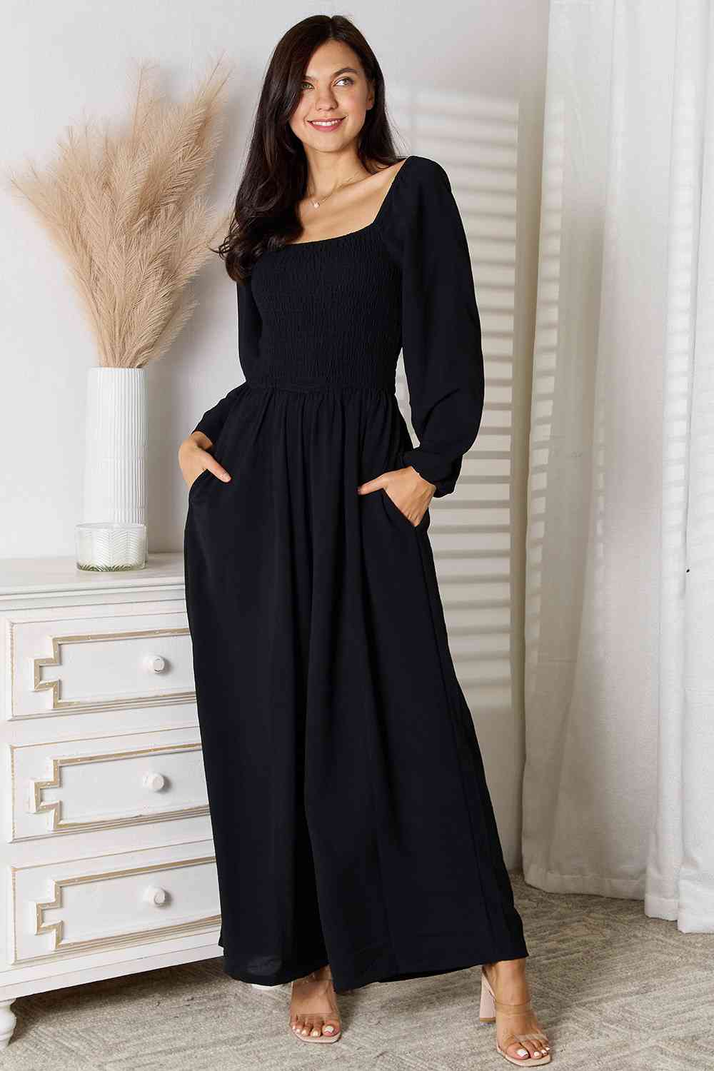 A stylish Double Take Square Neck Jumpsuit featuring pockets, showcasing its elegant design and smocked details.