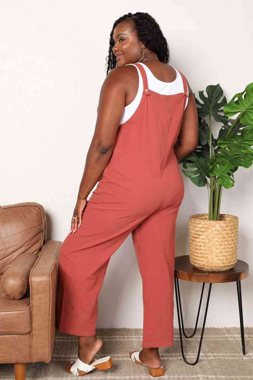 Double Take Wide Leg Overalls in solid color with front pockets, showcasing a trendy and comfortable fit.