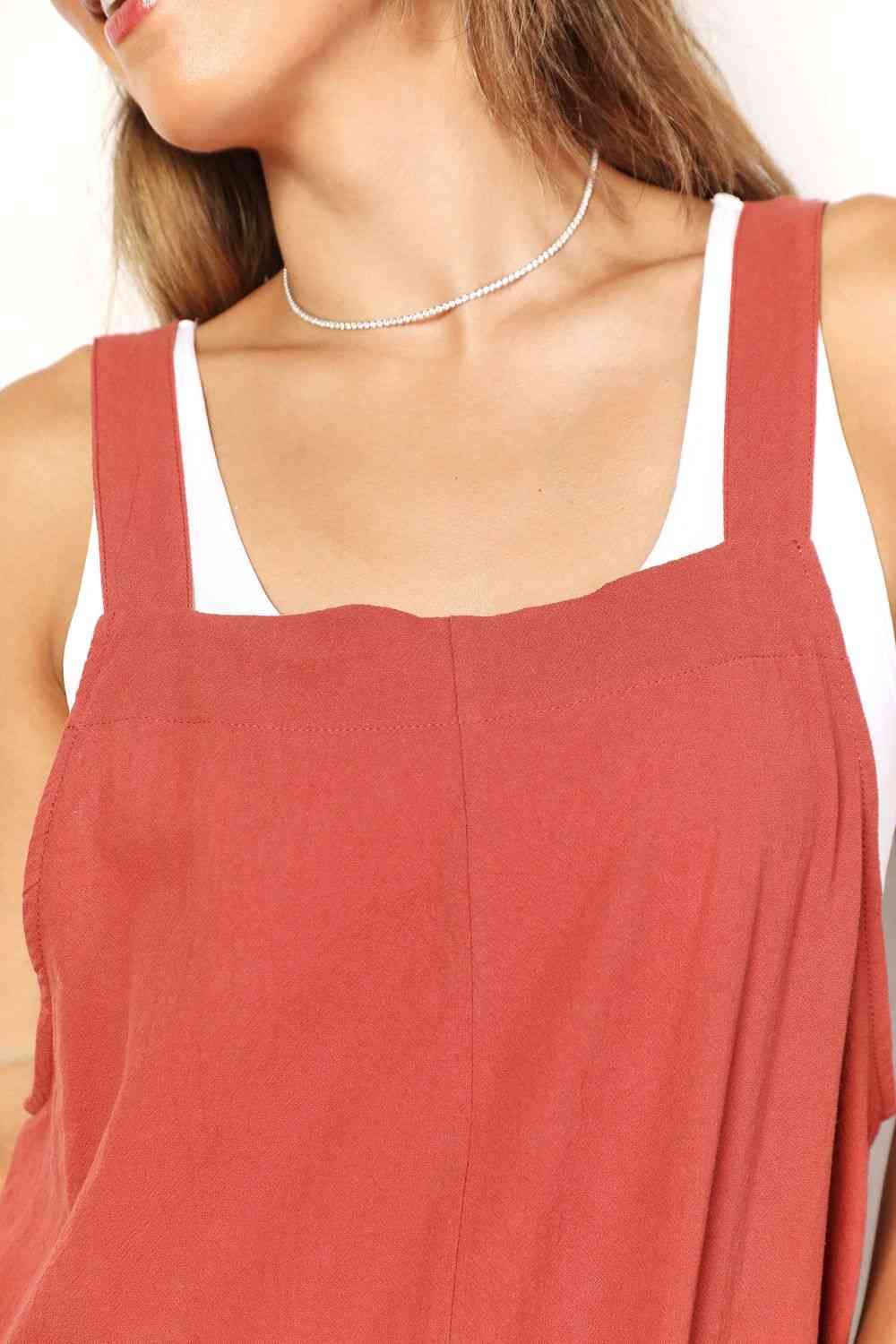 Double Take Wide Leg Overalls in solid color with front pockets, showcasing a trendy and comfortable fit.