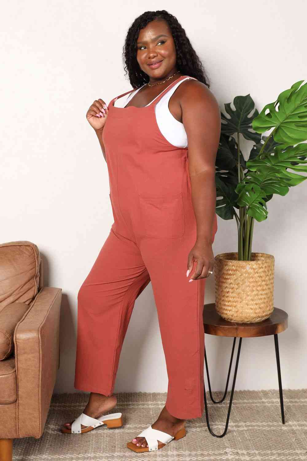 Double Take Wide Leg Overalls in solid color with front pockets, showcasing a trendy and comfortable fit.