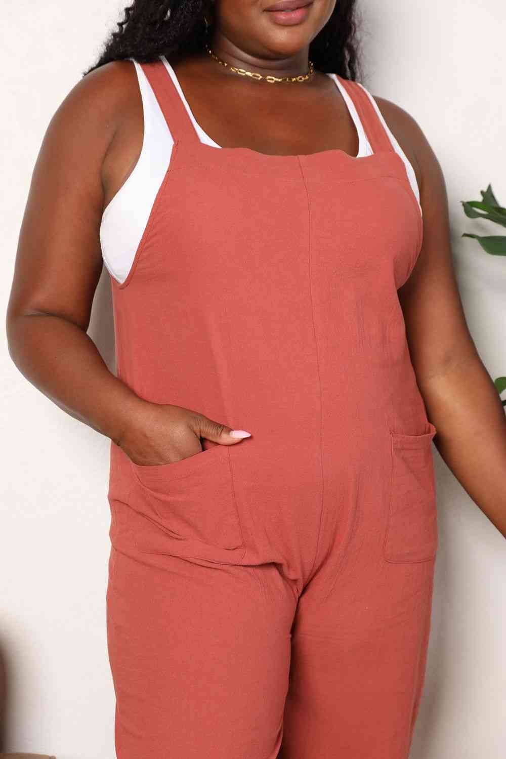 Double Take Wide Leg Overalls in solid color with front pockets, showcasing a trendy and comfortable fit.