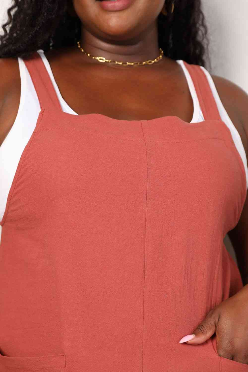 Double Take Wide Leg Overalls in solid color with front pockets, showcasing a trendy and comfortable fit.