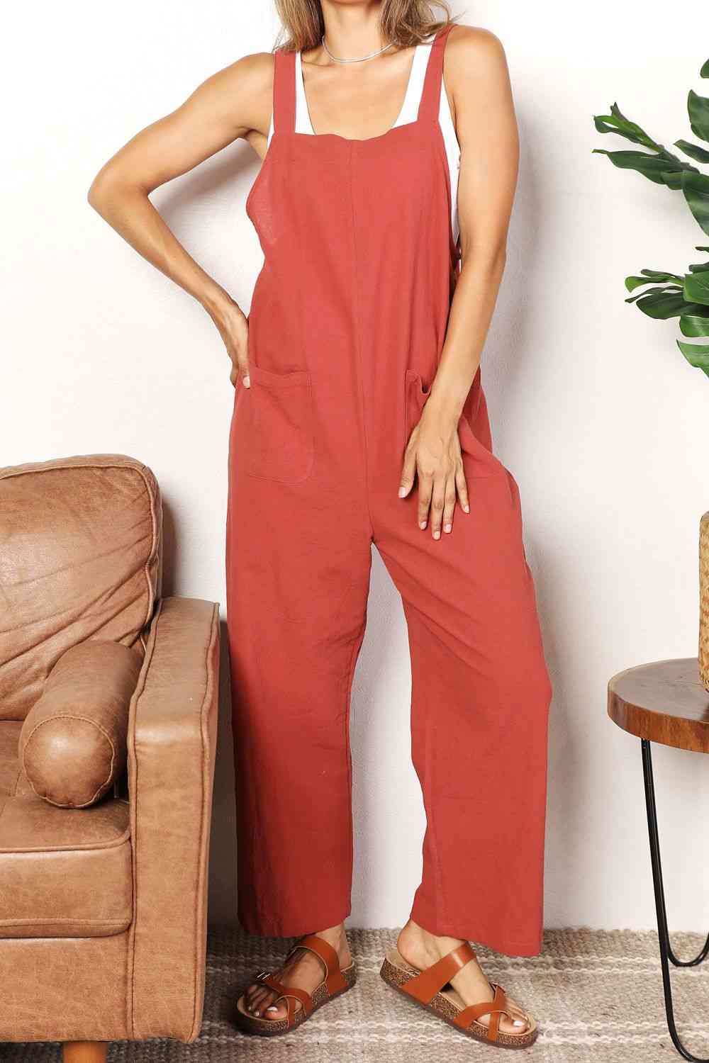 Double Take Wide Leg Overalls in solid color with front pockets, showcasing a trendy and comfortable fit.