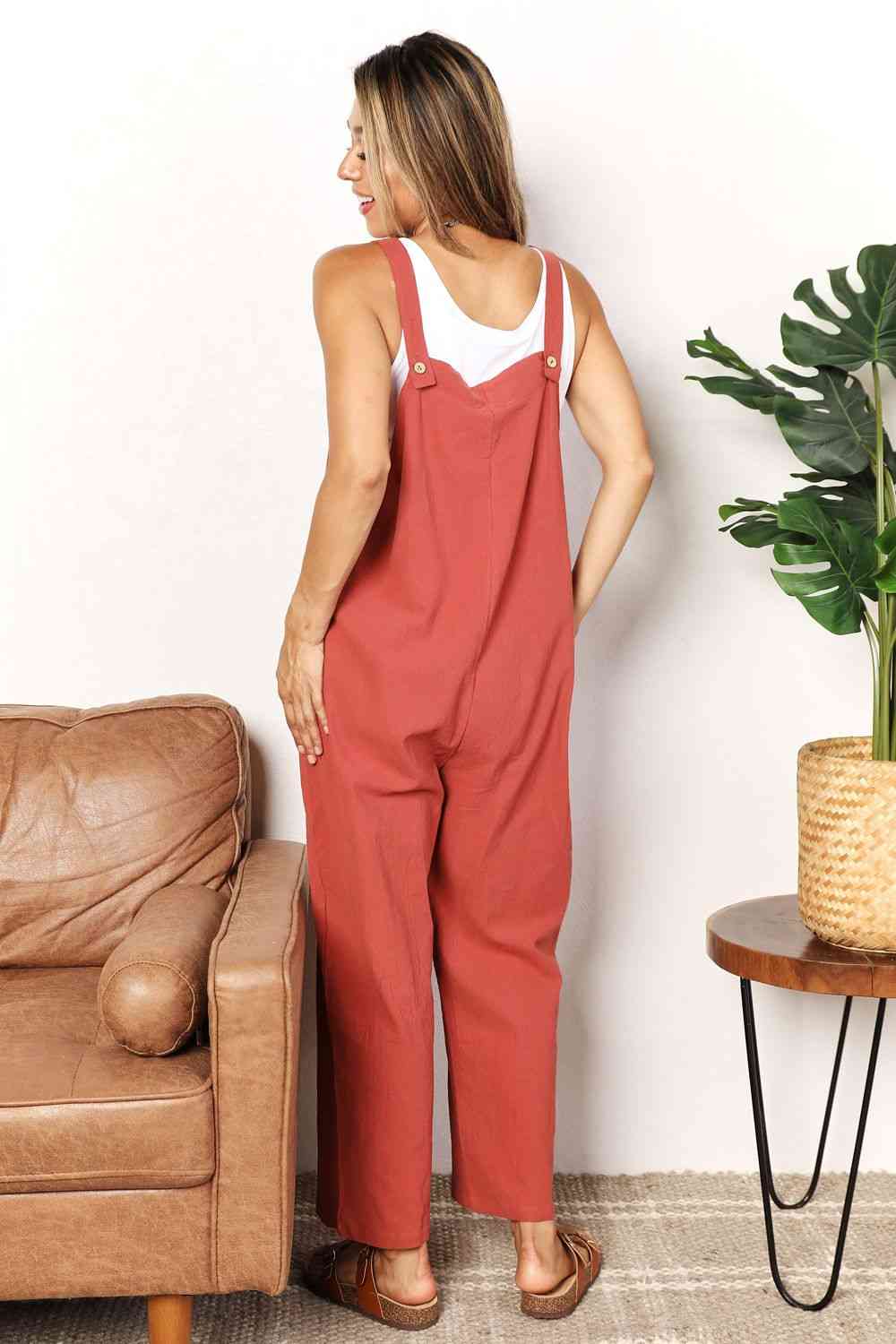 Double Take Wide Leg Overalls in solid color with front pockets, showcasing a trendy and comfortable fit.