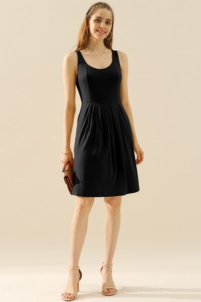 Doublju Full Size Round Neck Ruched Sleeveless Dress in a stylish design with pockets, showcasing its flattering silhouette and comfortable fabric.