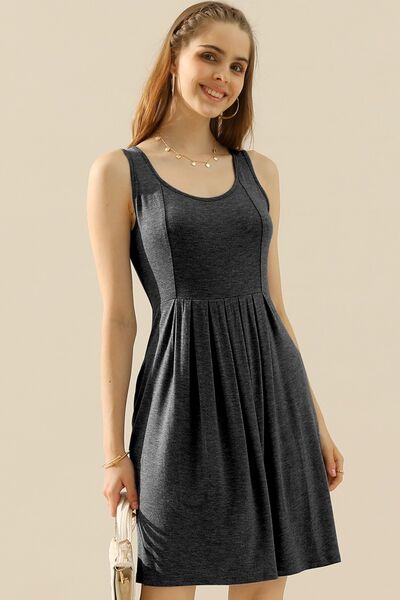 Doublju Full Size Round Neck Ruched Sleeveless Dress in a stylish design with pockets, showcasing its flattering silhouette and comfortable fabric.