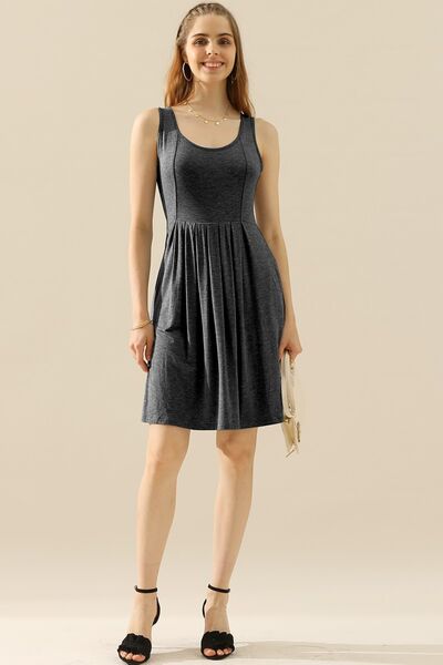 Doublju Full Size Round Neck Ruched Sleeveless Dress in a stylish design with pockets, showcasing its flattering silhouette and comfortable fabric.