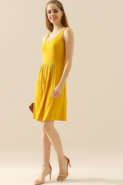 Doublju Full Size Round Neck Ruched Sleeveless Dress in a stylish design with pockets, showcasing its flattering silhouette and comfortable fabric.