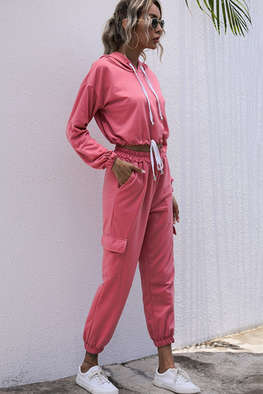 A stylish drawstring hem cropped hoodie paired with cargo joggers, showcasing a casual outdoor look.