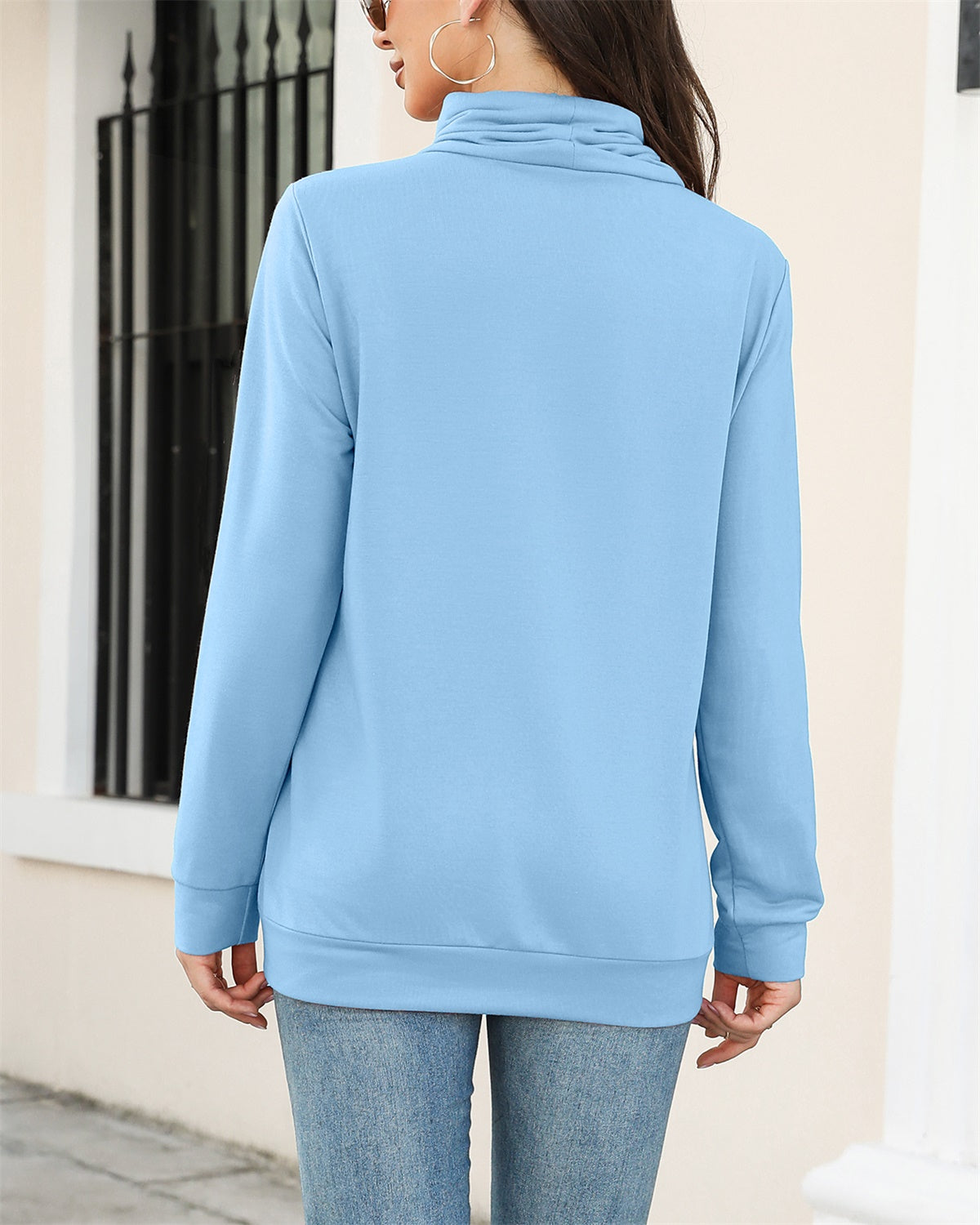 A cozy drawstring sweatshirt with side pockets, featuring a cowl neck design and long sleeves, available in various colors.