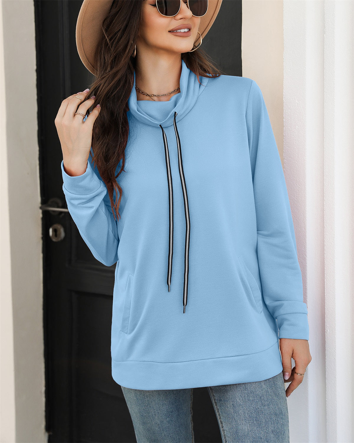 A cozy drawstring sweatshirt with side pockets, featuring a cowl neck design and long sleeves, available in various colors.