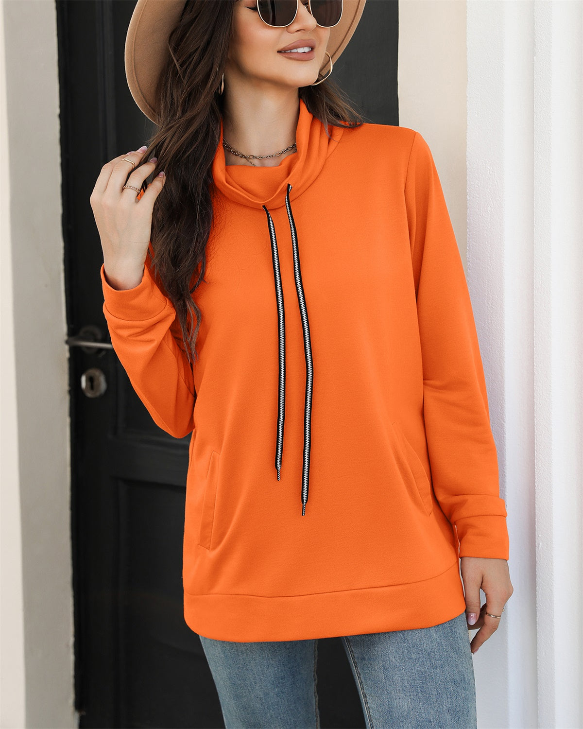 A cozy drawstring sweatshirt with side pockets, featuring a cowl neck design and long sleeves, available in various colors.