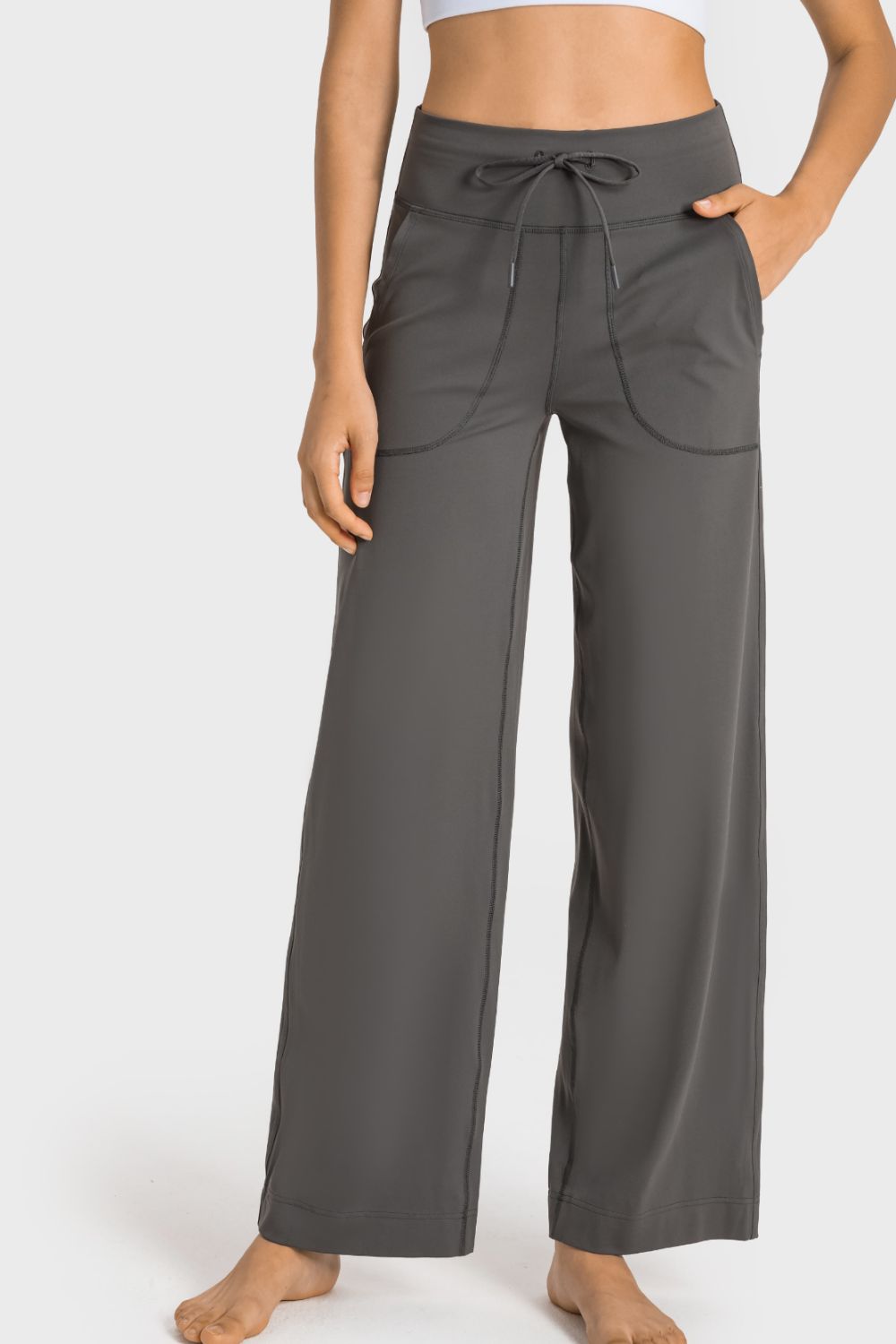 A pair of black drawstring waist wide leg sports pants with pockets, showcasing their soft fabric and stylish design.