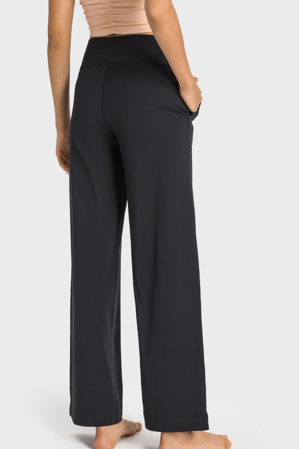 A pair of black drawstring waist wide leg sports pants with pockets, showcasing their soft fabric and stylish design.