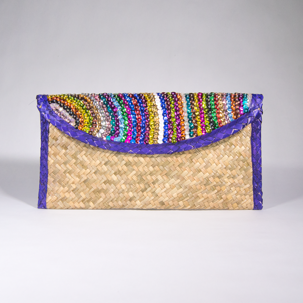 Eco-friendly clutch bag made from palm leaves with colorful sequin stripes and purple trim, showcasing artisan craftsmanship.