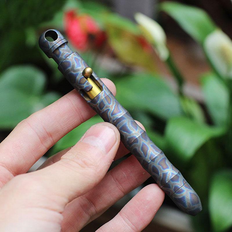 EDC Outdoor Titanium TC4 Krait Tactical Pen in three finishes: Natural, Stone Wash, and Flame, showcasing its sleek design and compact size.