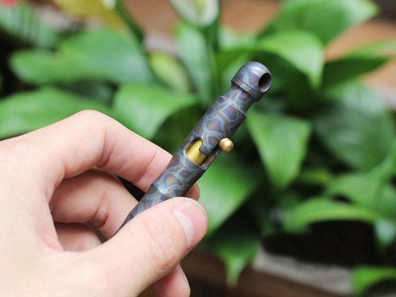 EDC Outdoor Titanium TC4 Krait Tactical Pen in three finishes: Natural, Stone Wash, and Flame, showcasing its sleek design and compact size.