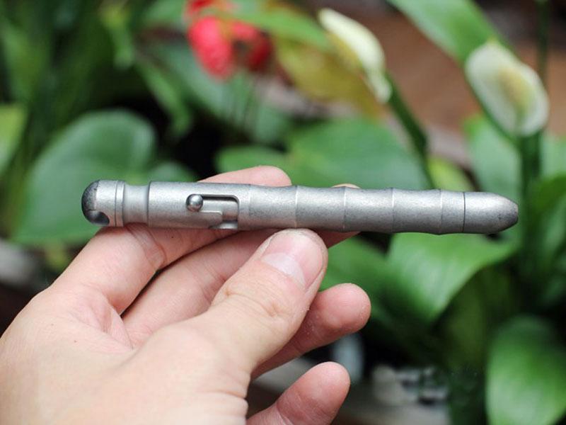 EDC Outdoor Titanium TC4 Krait Tactical Pen in three finishes: Natural, Stone Wash, and Flame, showcasing its sleek design and compact size.