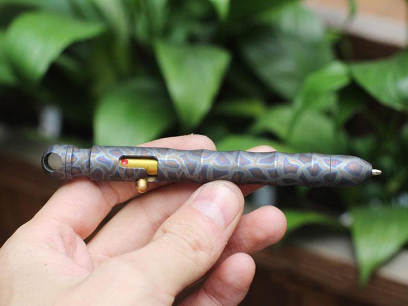 EDC Outdoor Titanium TC4 Krait Tactical Pen in three finishes: Natural, Stone Wash, and Flame, showcasing its sleek design and compact size.