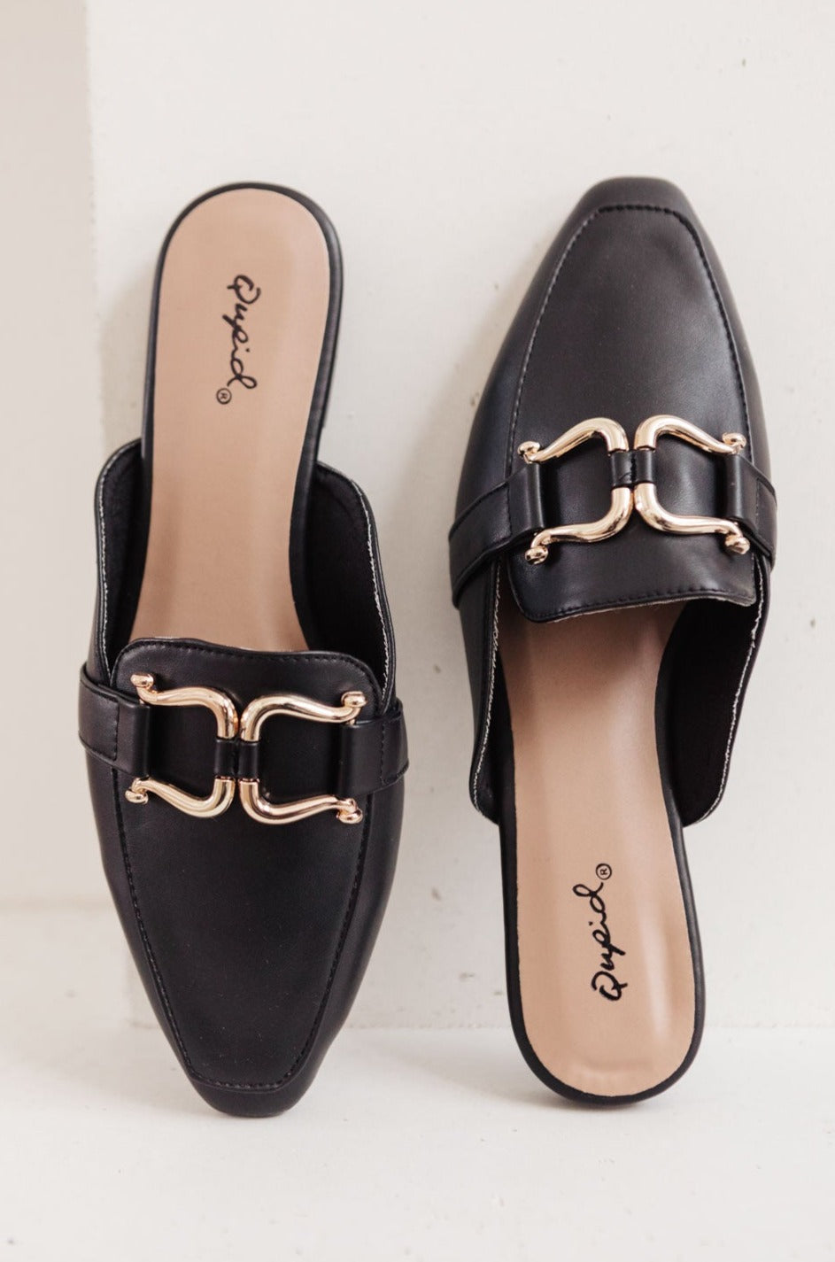 Ella Fae Slides featuring a pointed toe and gold horsebit detail, crafted from faux leather for a chic minimalist look.