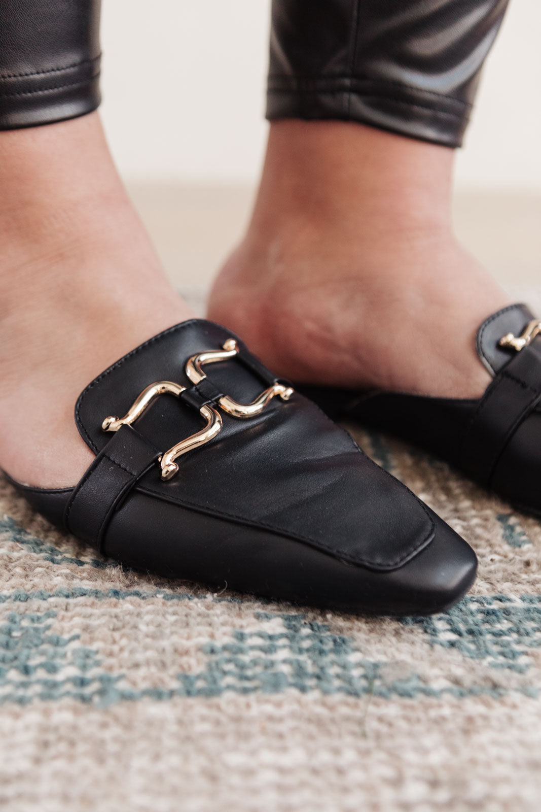 Ella Fae Slides featuring a pointed toe and gold horsebit detail, crafted from faux leather for a chic minimalist look.