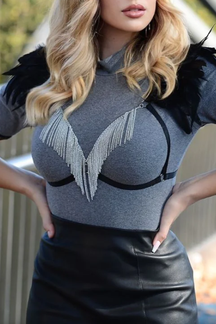Black elastic strap bra with decorative feathers on shoulders and metal chains on the front, showcasing a stylish and edgy design.
