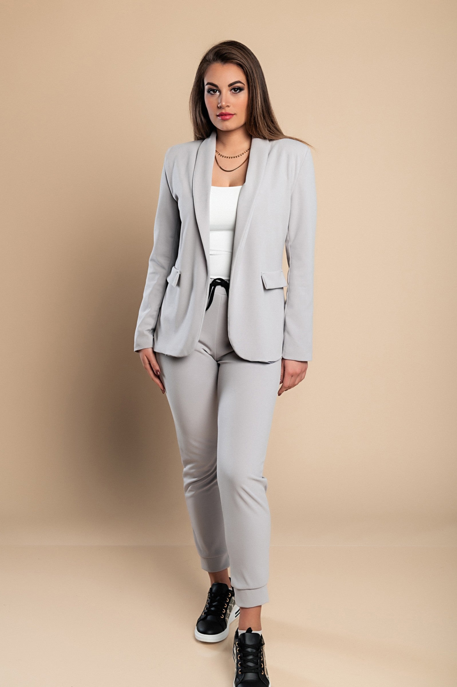 Elegant light gray blazer and pants set Estrena, showcasing a classic collar, long sleeves, and fitted trousers with a drawstring waist.