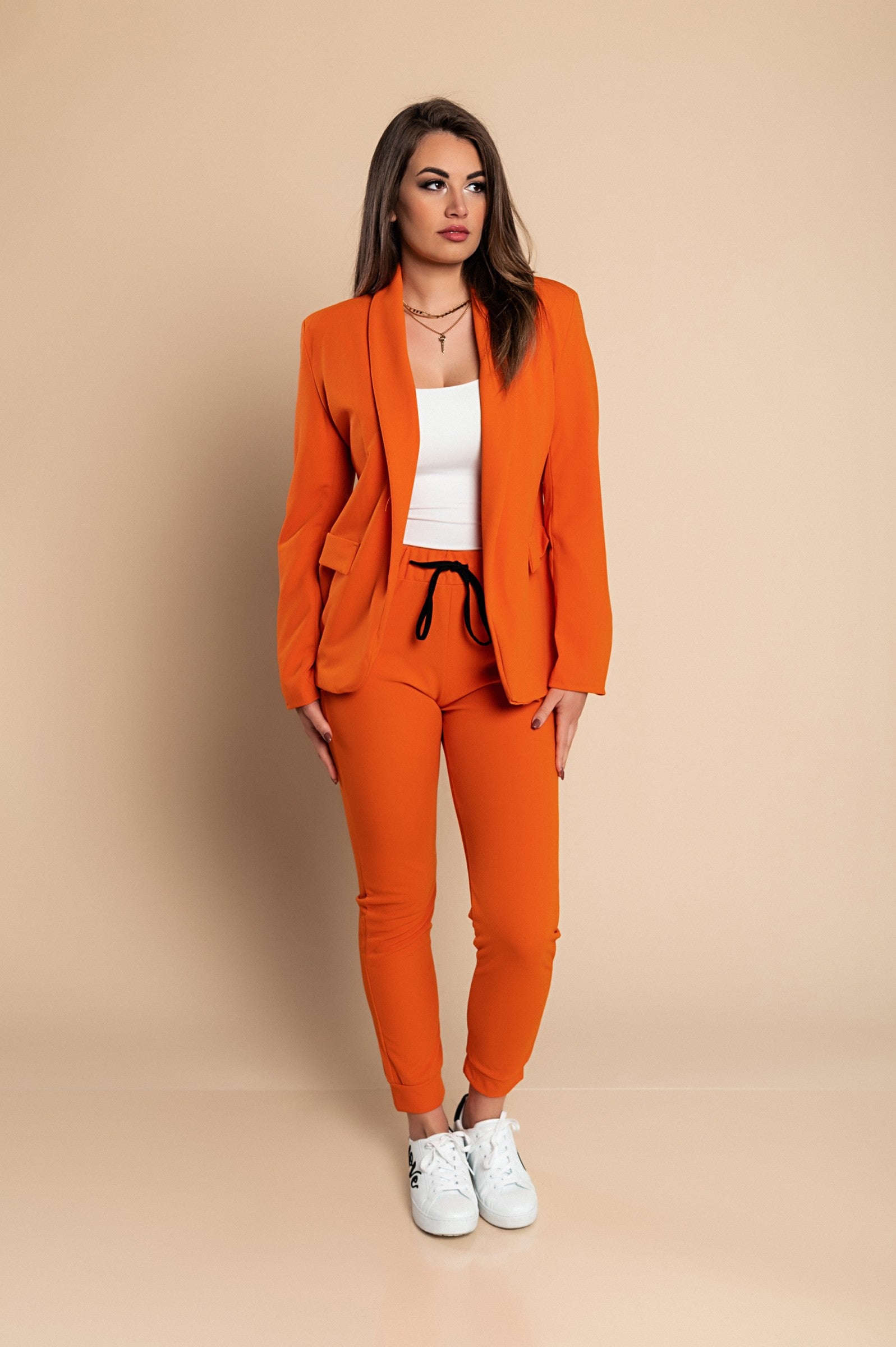 Elegant orange blazer and pants set Estrena, showcasing classic collar and long sleeves, perfect for stylish occasions.