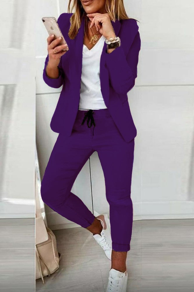 Elegant purple blazer and pants set Estrena, showcasing a classic collar, long sleeves, and fitted trousers with a drawstring waist.