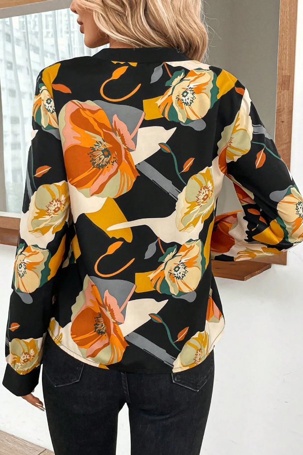 Elegant multicolor blouse with floral print, featuring a V-neck and long sleeves, made from lightweight polyester fabric.
