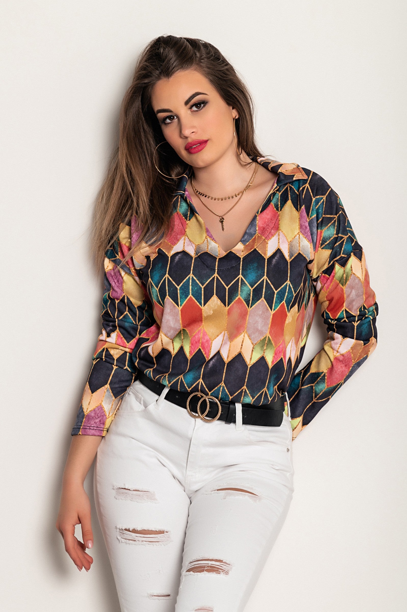 Elegant pink blouse with long sleeves, featuring a geometric print and a 'V' neckline, perfect for stylish comfort.