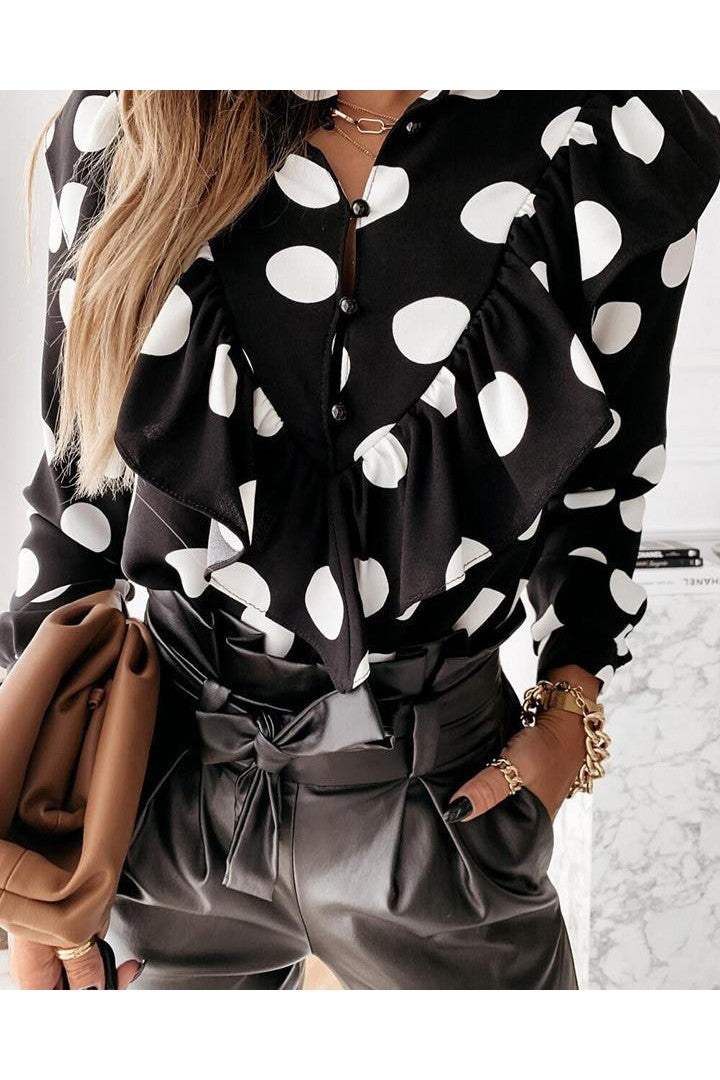 Elegant black blouse with polka dot print and decorative ruffles, featuring a classic collar and long sleeves.