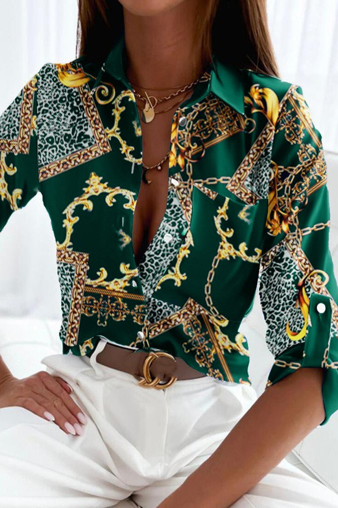 Elegant petrol blouse with geometric print, classic collar, and long sleeves, made from high-quality imitation satin.