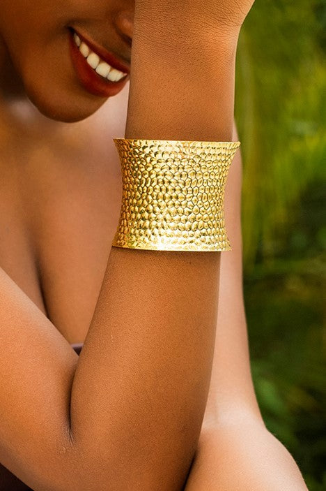 Elegant gold bracelet with a wide design, perfect for enhancing any outfit.