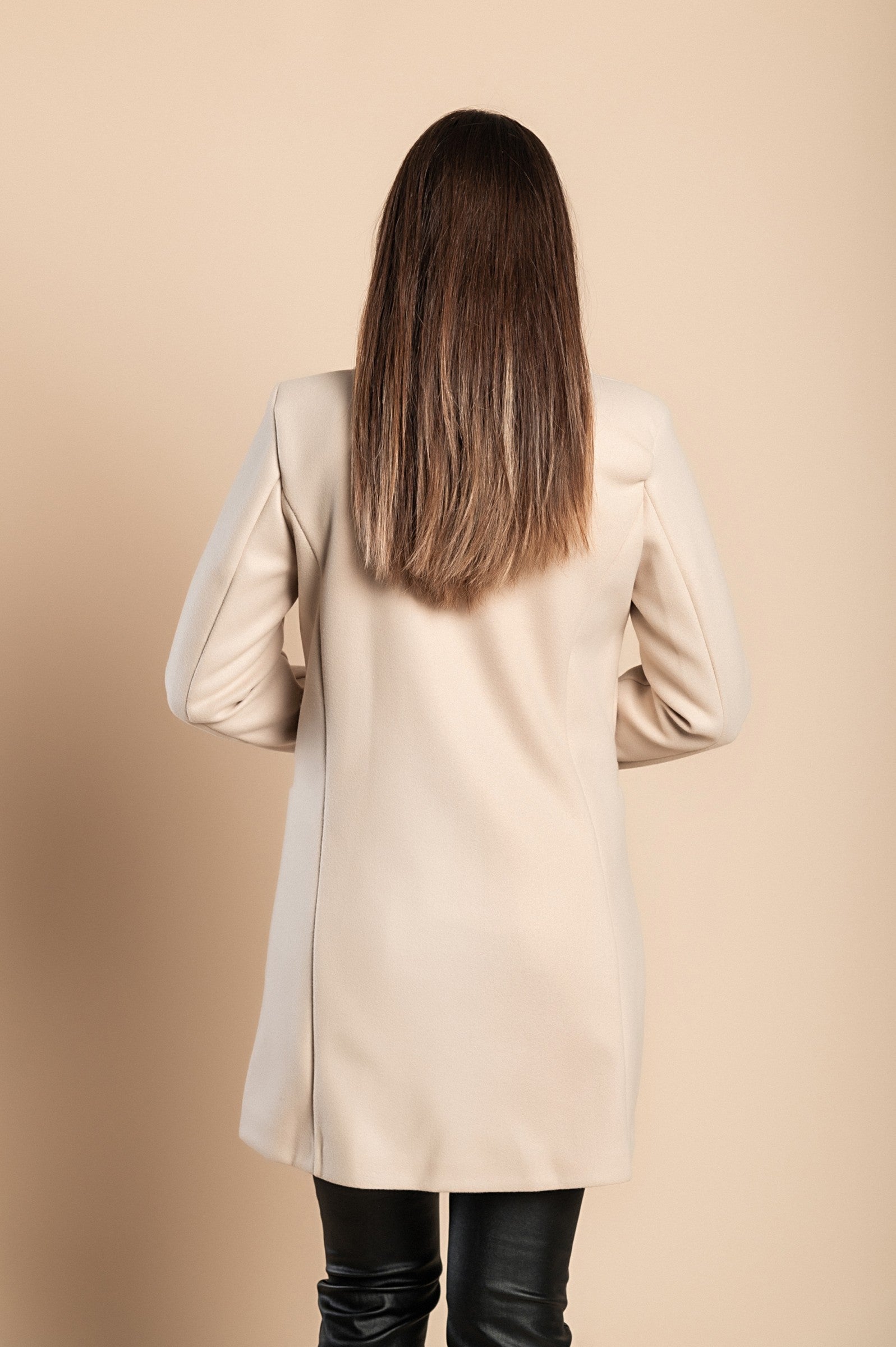 Elegant beige coat with one button, featuring a classic collar and side pockets, made from high-quality polyester.