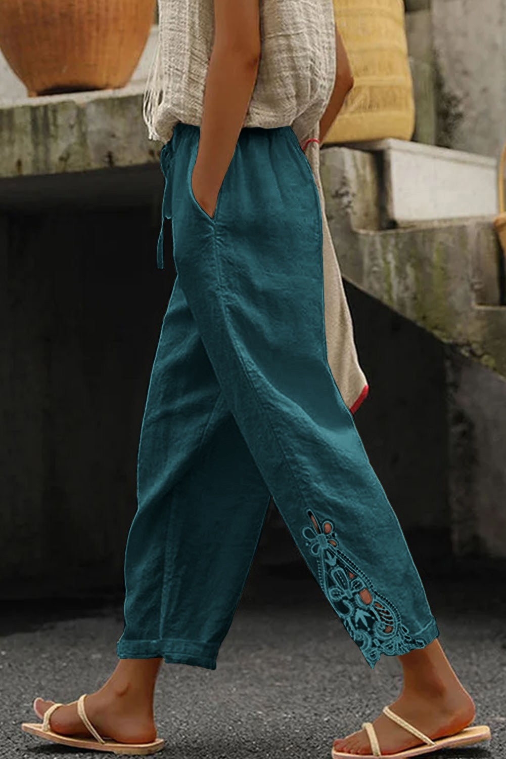 Elegant petrol cotton trousers with lace detailing, featuring an elastic and drawstring waist, designed for comfort and style.