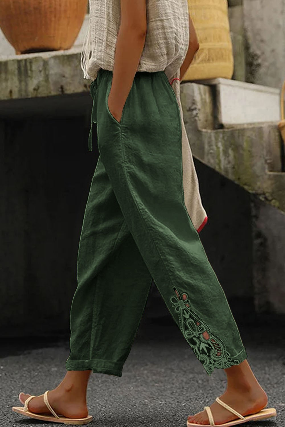 Elegant olive green cotton trousers with lace trim, featuring an elastic drawstring waist and 7/8 length design.
