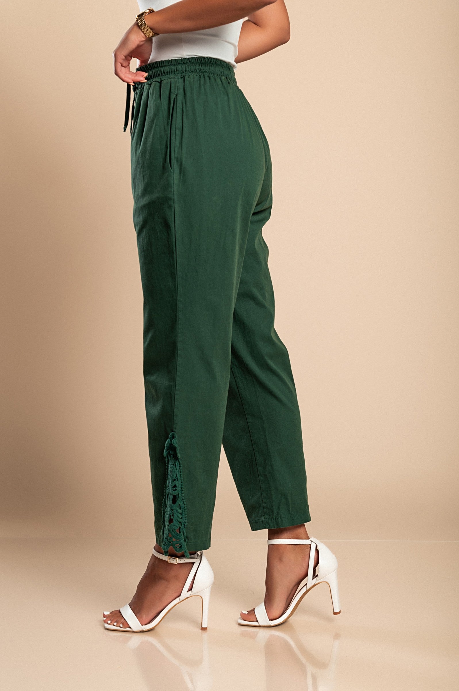 Elegant olive green cotton trousers with lace trim, featuring an elastic drawstring waist and 7/8 length design.