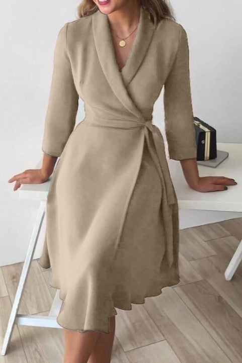 Elegant beige dress with folding collar and 3/4 sleeves, showcasing a deep V neckline and waist tie.