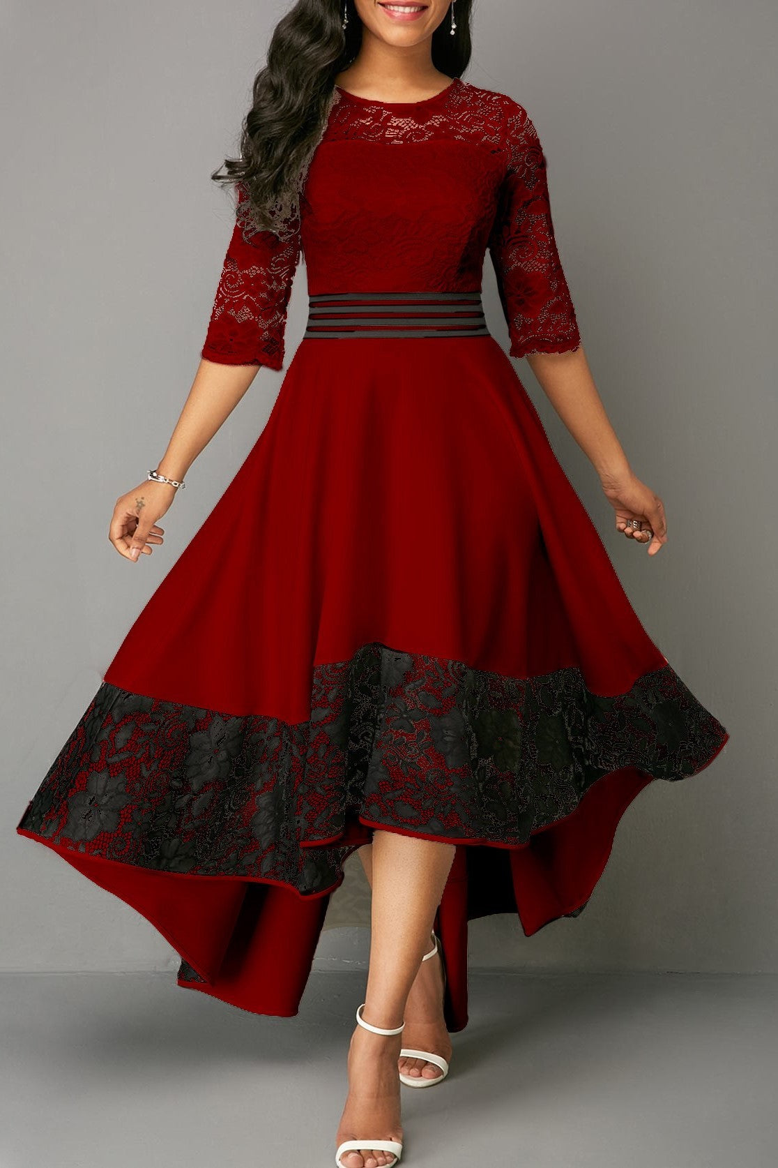 Elegant burgundy dress with lace detailing, featuring an asymmetrical design and sheer 3/4 sleeves, perfect for sophisticated occasions.