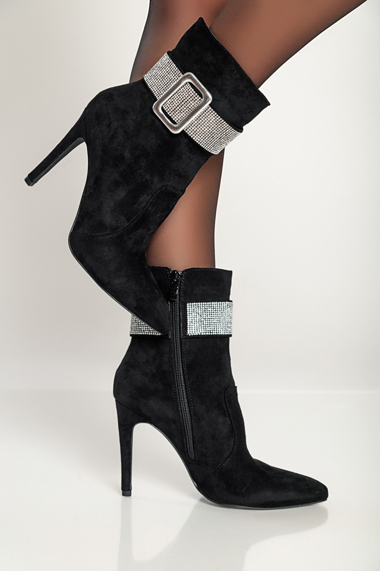 Elegant black high-heeled ankle boots with rhinestone detail and inside zipper closure, featuring a pointed toe and thin heel.