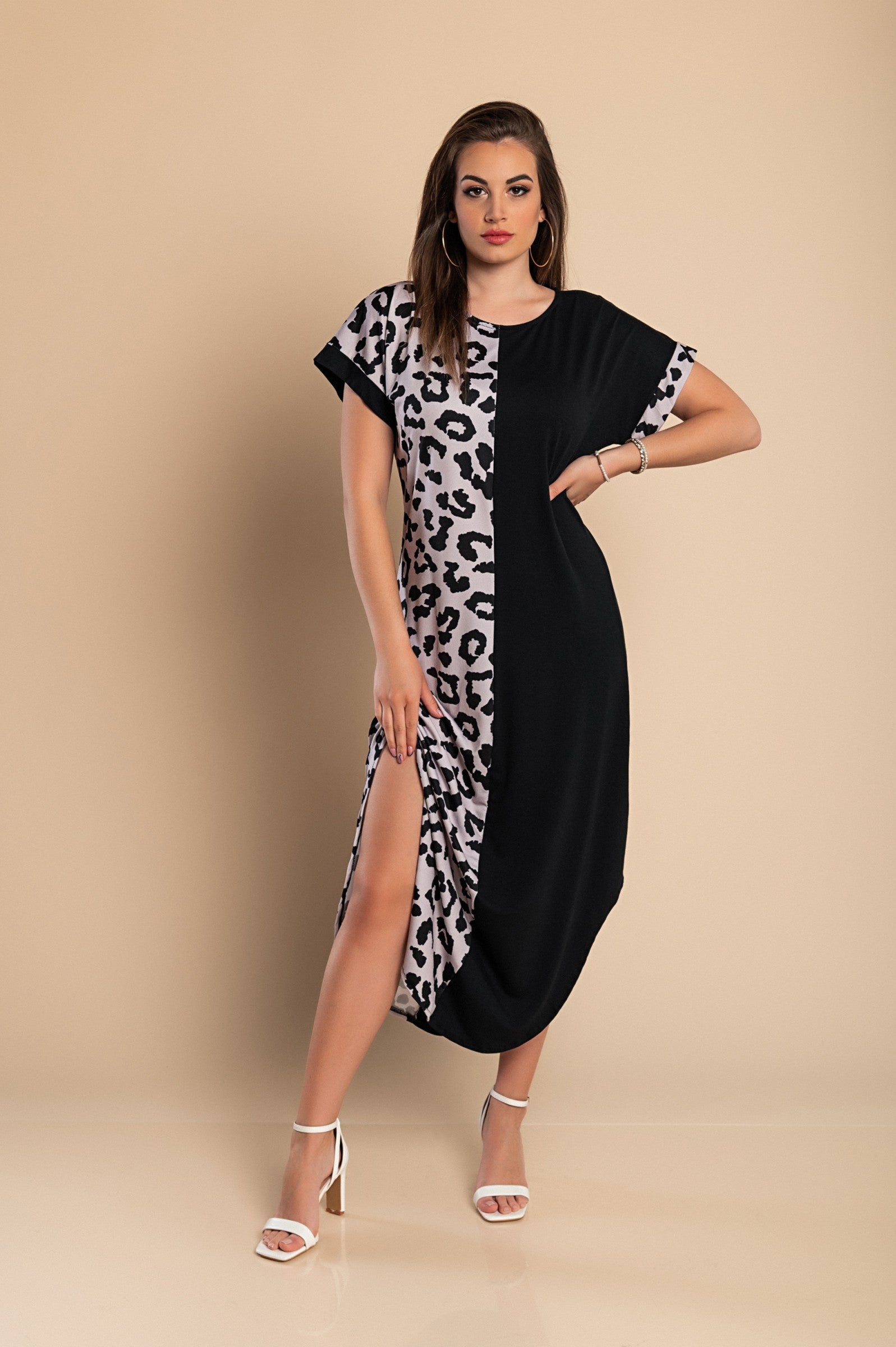 Elegant black maxi dress featuring a leopard print design, loose fit, round neckline, and side slits.