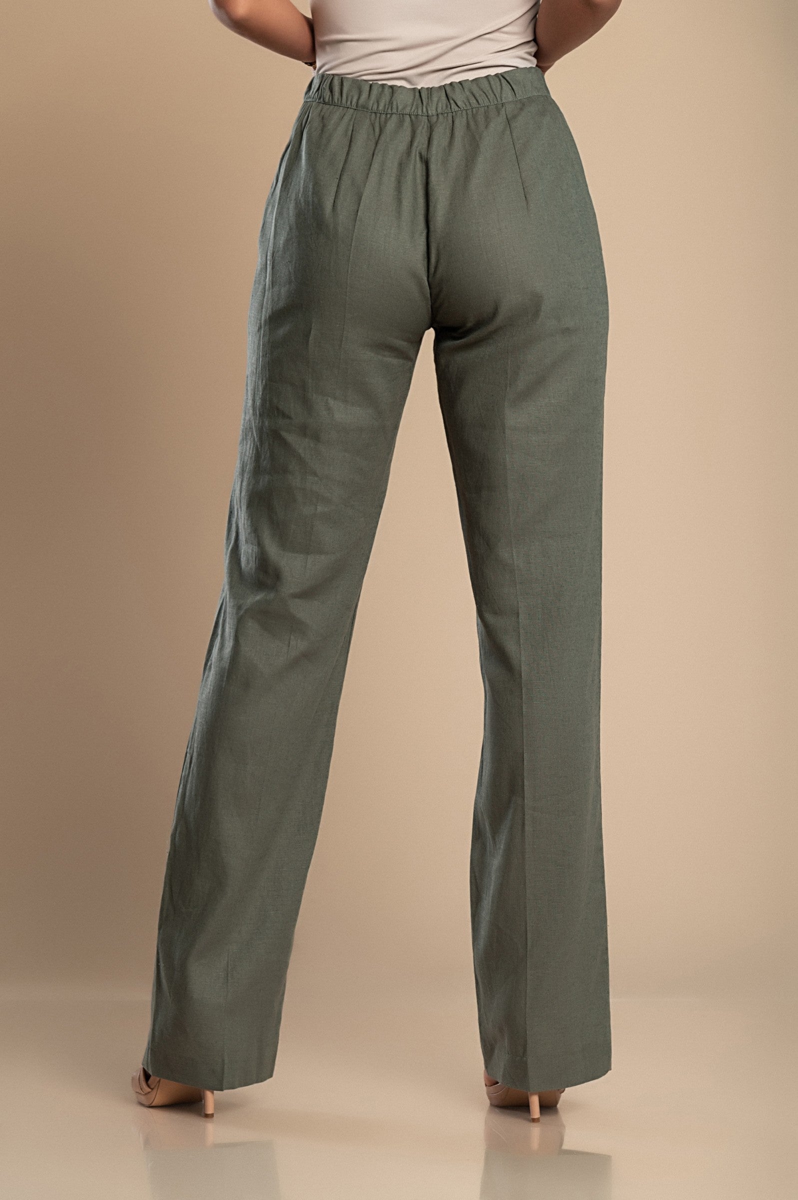 Elegant olive green linen trousers with a straight cut, featuring a drawstring waist and elastic back for comfort.