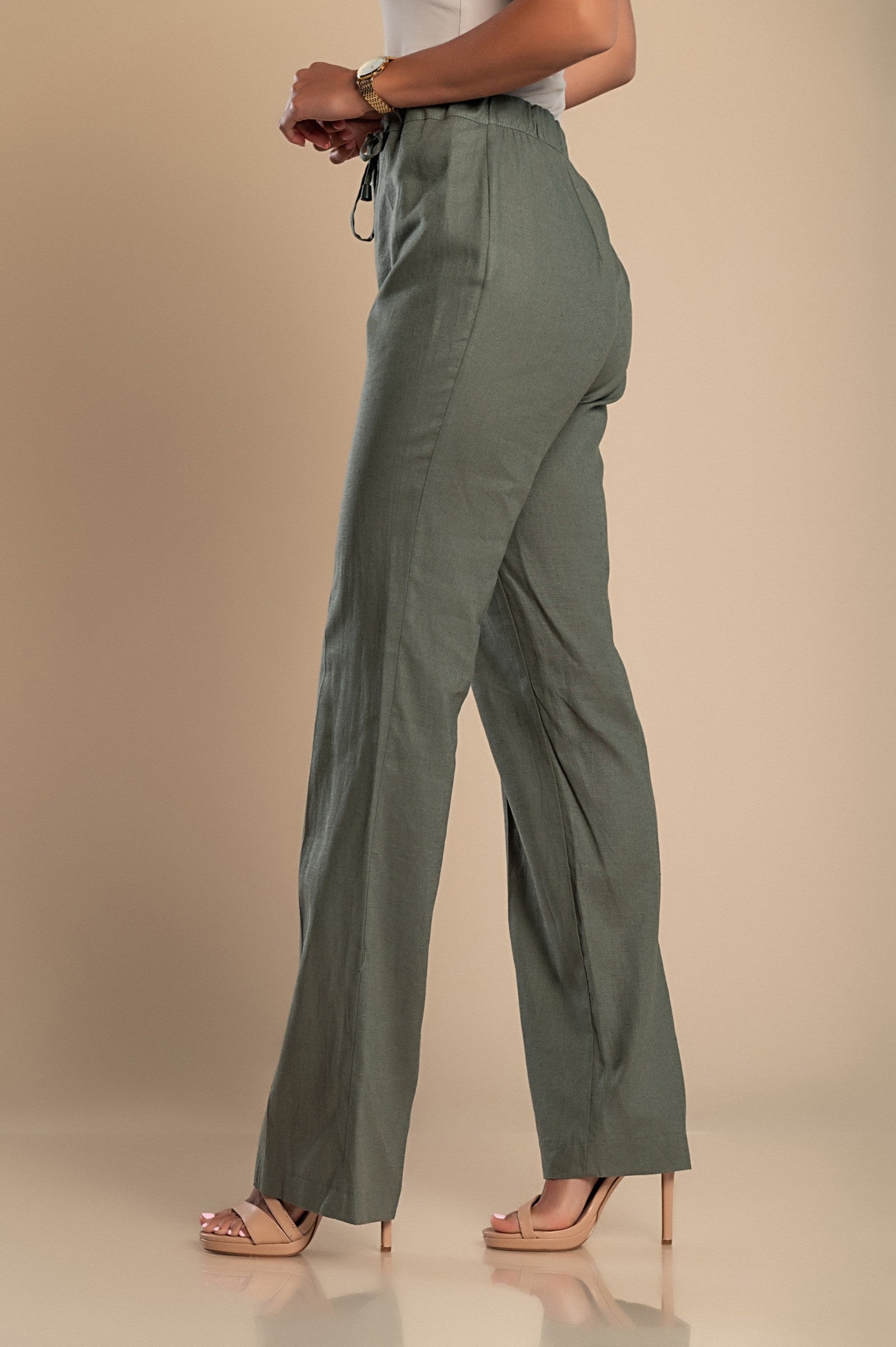 Elegant olive green linen trousers with a straight cut, featuring a drawstring waist and elastic back for comfort.
