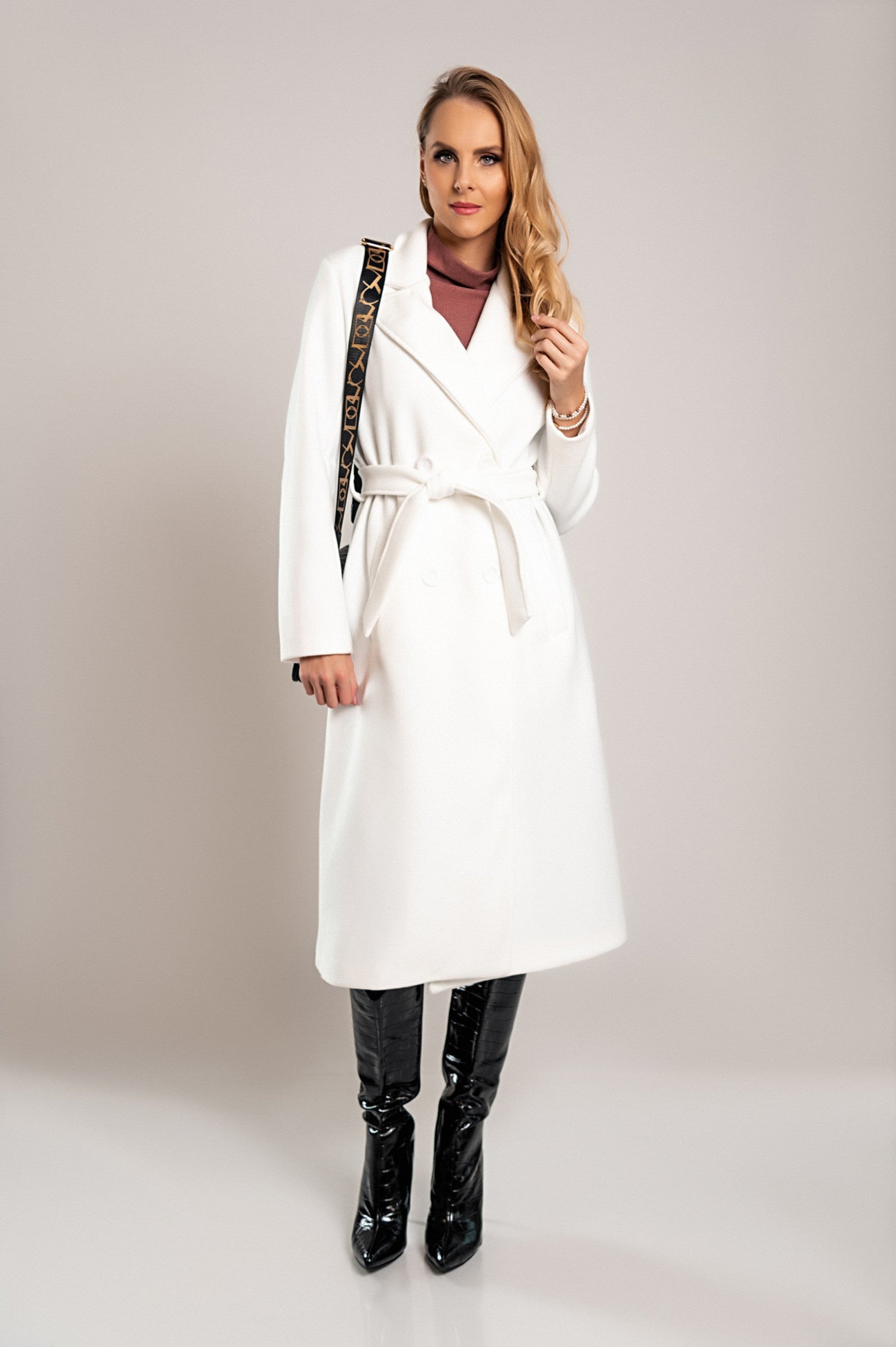 Elegant long white coat with buttons, featuring a classic collar and decorative belt, made from high-quality soft fabric.