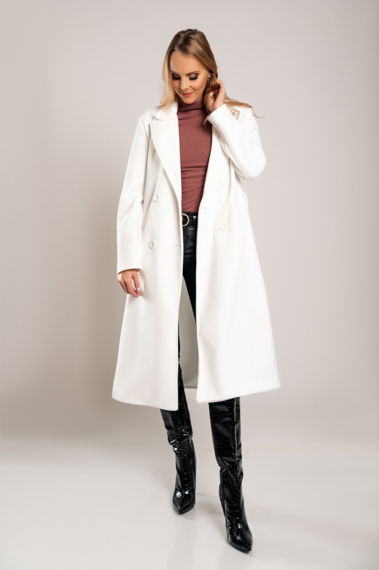 Elegant long white coat with buttons, featuring a classic collar and decorative belt, made from high-quality soft fabric.
