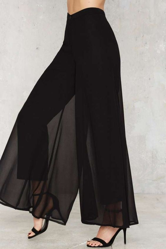 Elegant long pants Veronna in black, featuring a loose fit and high waist with a sheer top layer, made from soft and compact fabric.